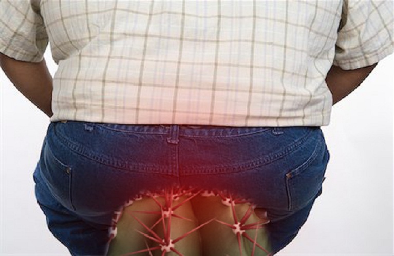 Person holding their lower back in discomfort